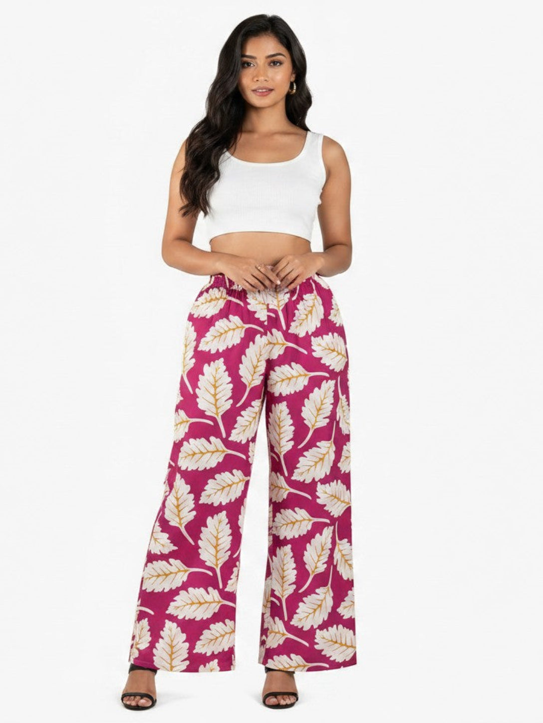 Model wearing ATHLEX SHOP pink wide-leg palazzo pants with white leaf print, elastic waist, and soft fabric.
